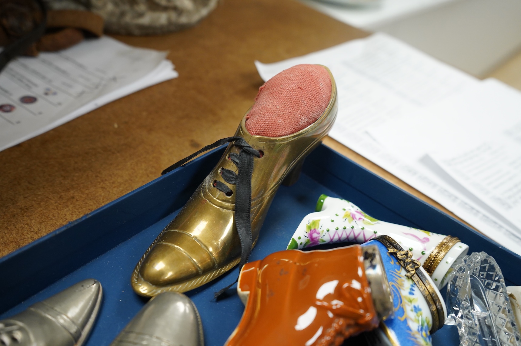 A collection of assorted miniature model shoes including pin cushions, one with modern silver mount